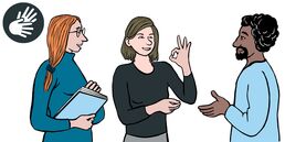 Eine Frau mit Papieren in der Hand schaut auf eine Frau. Diese formt mit Daumen und Zeigefinger der linken Hand einen Kreis. Die anderen Finger sind abgespreizt. Ein Mann mit schwarzem Haar und dunkler Haut steht vor der gestikulierenden Frau und lächelt
